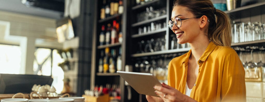 Restaurant manager utilizing a centralized payroll platform. 